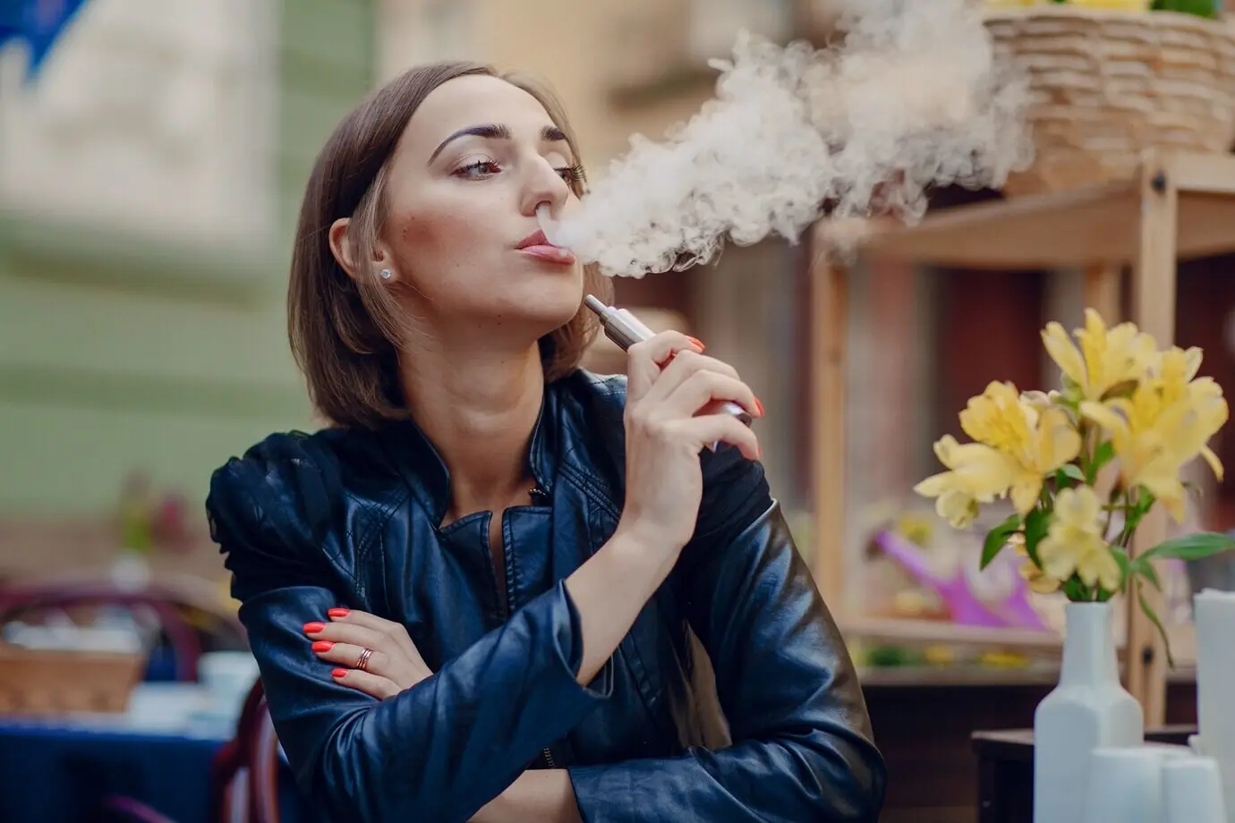 A calm woman smoking an electronic cigarette