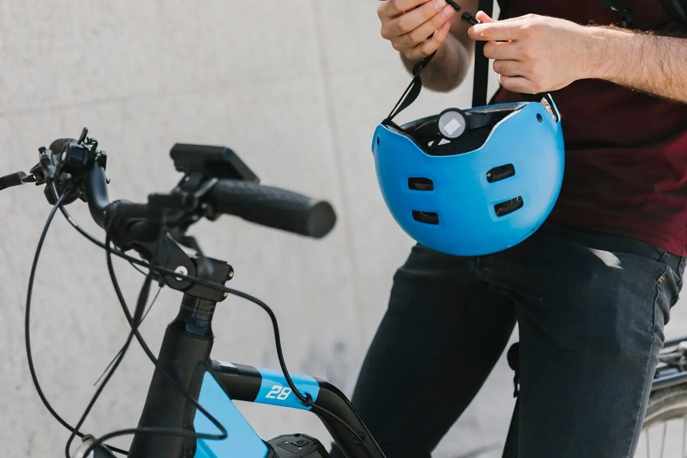 Close-up of a man holding a helmet on a bicycle